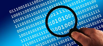 Person, looking on the blue and white binary code, with the magnifying glass in the hand