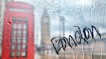 glass with the word london on the background of the city