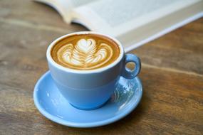 Latte with art and open Book
