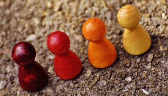 wooden colorful figurines on the asphalt close up