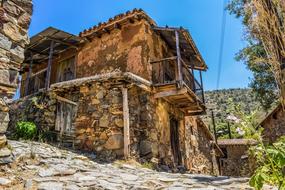 Beautiful old buildings, among the colorful plants, in Fikardou village, on Cyprus, Greece