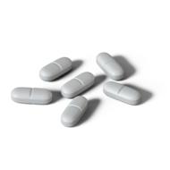six pills on white background