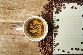 notebook among coffee beans as conceptual design