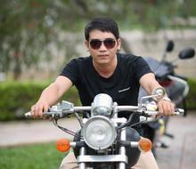 young man in sunglasses on a motorcycle close up