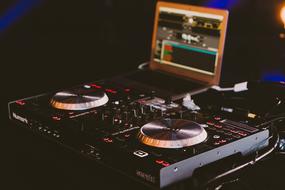 closeup view of dj turntable with screen in studio