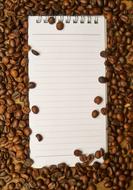 notepad and roasted coffee beans