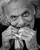photo of a homeless man eating food on the street