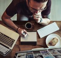 man with coffee working in the office