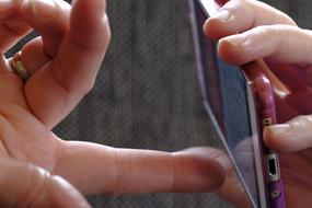 smartphone in hands close-up on blurred background