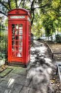 London phone booth in the shade of trees