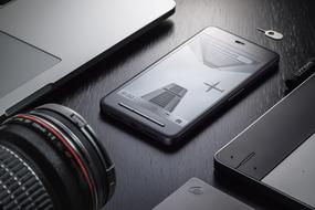 Beautiful dark devices and smartphone with the photo of buildings and aircraft