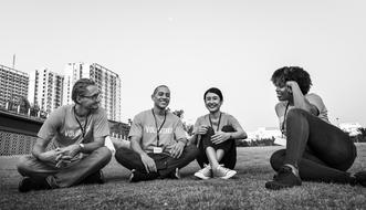 black and white photo of volunteers from different countries on the lawn
