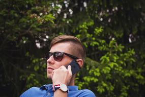 guy in sunglasses talking on iphone