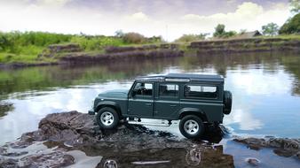 Beautiful landscape with the green car, on the rocks, among the river, among the beautiful, green shore