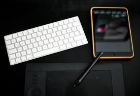 mobile phone near white keyboard