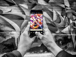 photo of multicolored graffiti on a smartphone screen