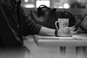 person with smartphone at table in cafe, Black And White