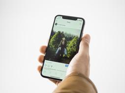 smartphone with photo of happy young couple in male hand