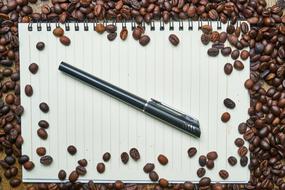 Coffee beans and Notebook Pen