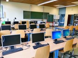 computers are on the tables in the classroom