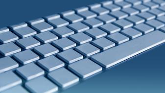 blank computer keyboard on blue background