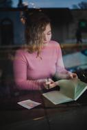 girl reading a book in a cafe