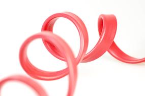 Close-up of the shiny, pink computer cable, at white background