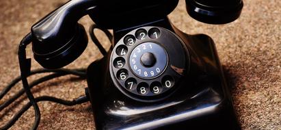 black old telephone with numbers