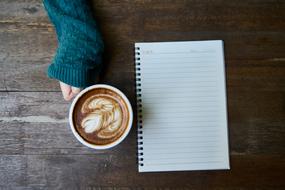 Coffee Cup Beverage and notebook on desk