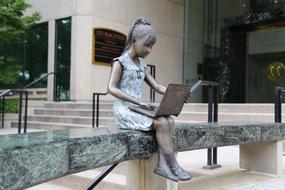 girl with laptop as a statue