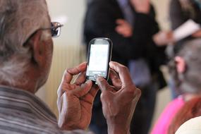 mobile phone in hands of an old man