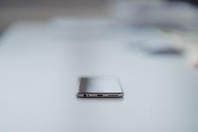 smartphone on a white surface in a blurred background