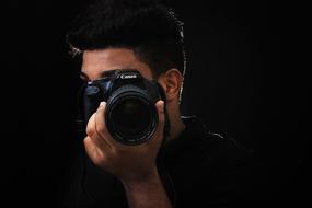 tanned guy with black photo camera