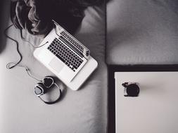 Macbook Laptop and Headphones on sofa