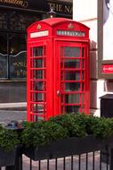 red telephone booth on the street in London