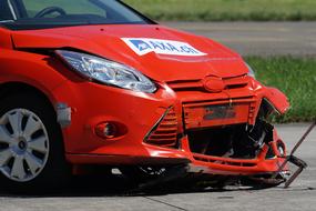 broken red car after crash test