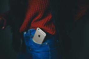 Ipone in the pocket of a blue jeans of a person