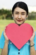 asian girl is holding pink paper heart