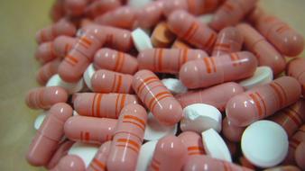 macro photo of white and pink pills