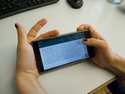 text on smartphone screen in hands