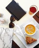 tablet, sunglasses and breakfast on the table