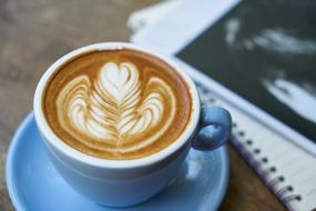 coffee with foam pattern in a blue cup