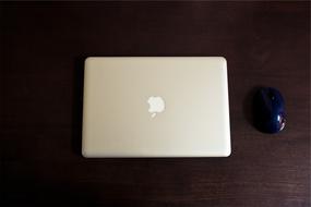 macbook pro and black computer mouse on the table