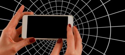 Smartphone in female Hands at white circular grid