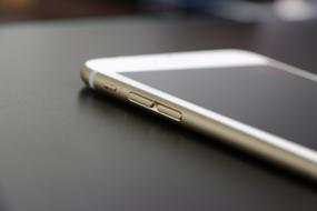 Beautiful, shiny, white Iphone 6 plus on the black table