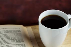 black coffee and open book close up