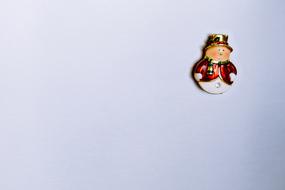 Beautiful and colorful Christmas snowman in hat, on the white wall