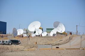 many satellite antennas on the hill on a sunny day