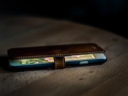 Smartphone in a case on a wooden table close-up