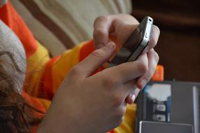 Iphone 4 in child girlâs hands